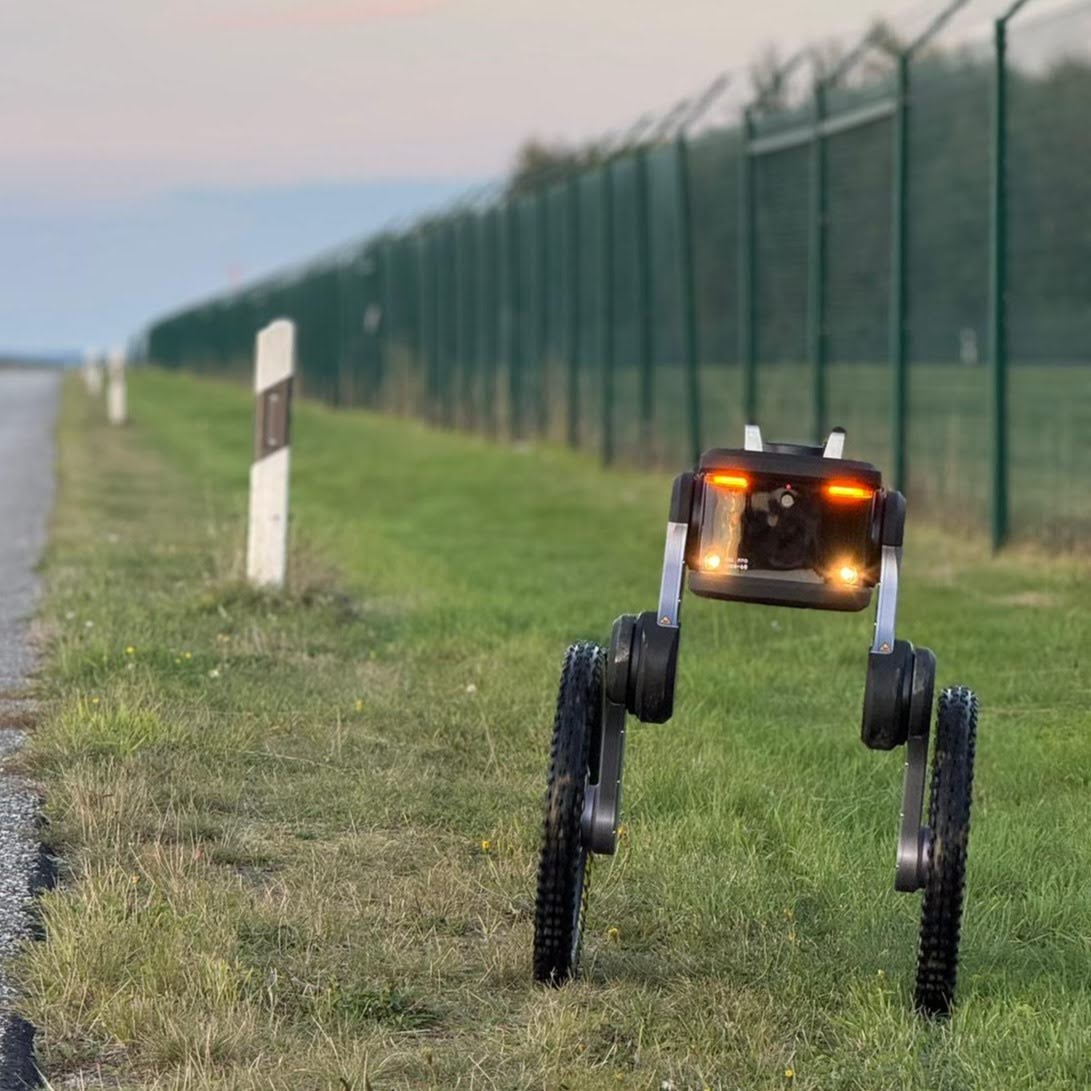 Ascento source photograph of an outdoor patrol robot beside a perimeter. Context for the supplier’s October commentary, not an independent reliability test.