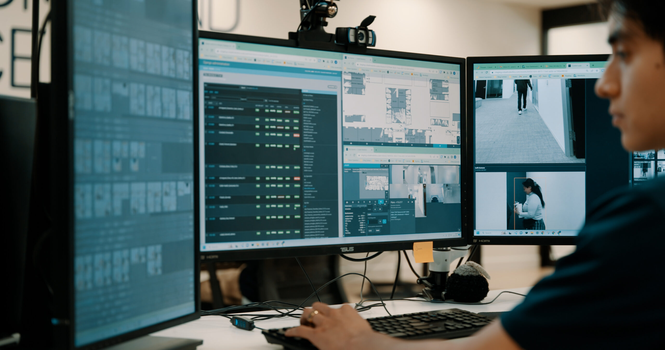 Cobalt AI source photograph of a monitoring specialist and workstation. Archived operational context, not a photograph of the October 2026 summit or a measured customer result.