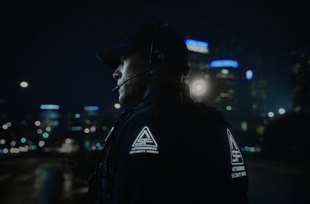 Knightscope media-kit photograph of a security agent at night. Human-service context; not a screenshot of Signals or a documented response to a particular robot alert.
