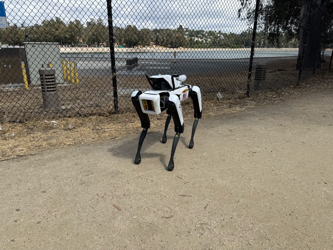DroneDog beside a fence at a water treatment facility